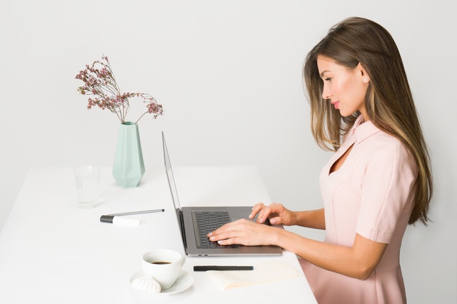 woman-in-pink-dress-using-laptop-computer-1586973.jpg